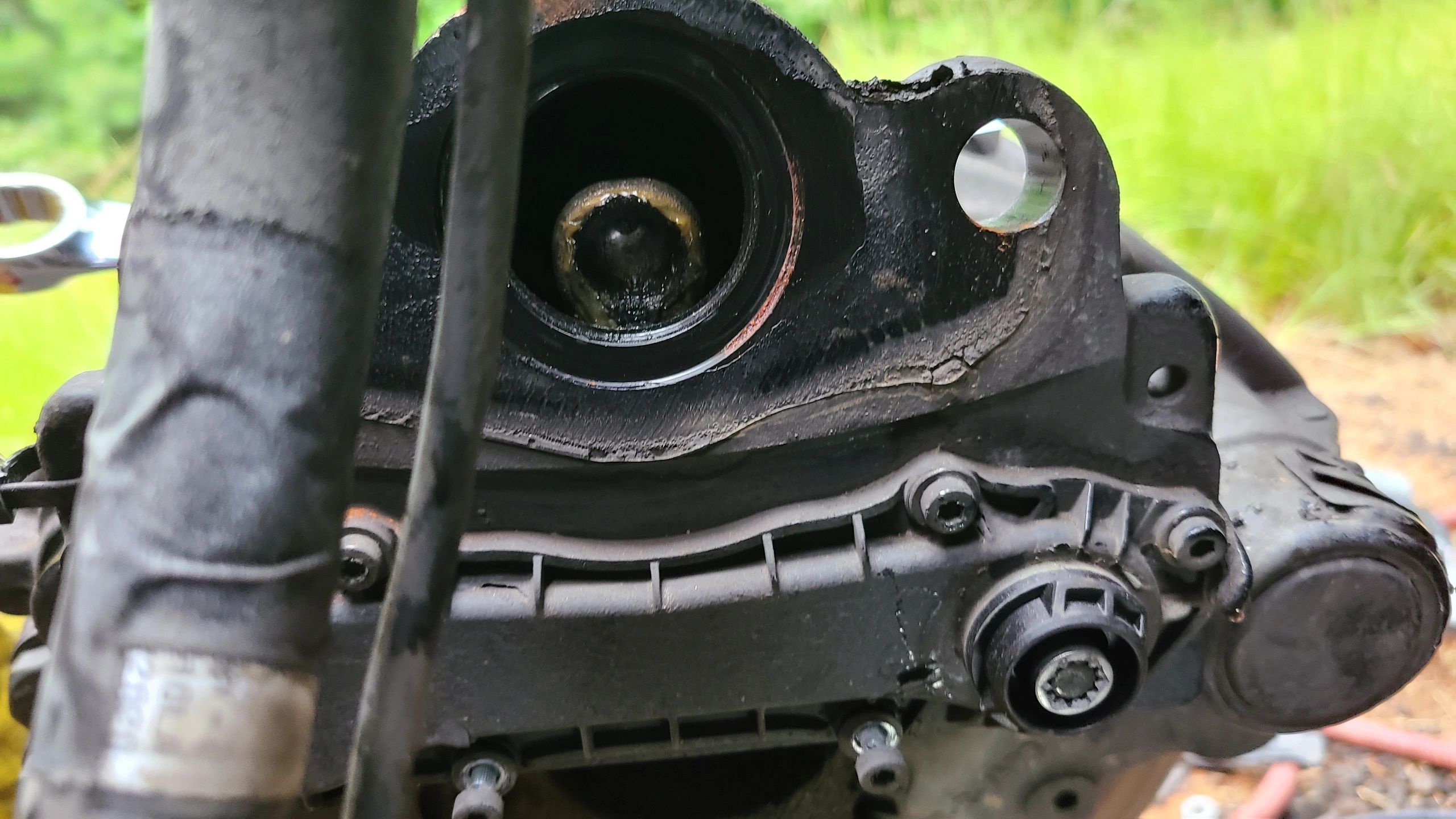 Tech On The Way — close-up of a disassembled brake caliper on a customer vehicle during a mobile brake-pad service call